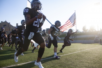 Football Team Running onto Field