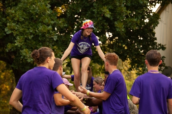 Builder Camp 2021 - Smiling girl being lifted up by group
