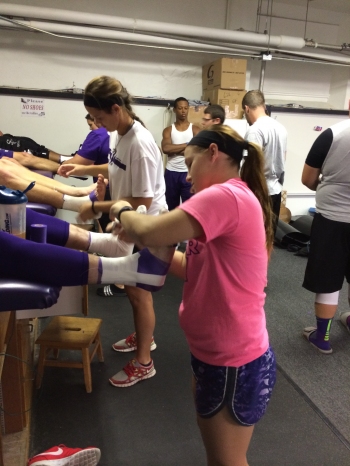 Athletic Training Students Wrapping Ankles