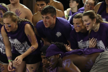 Students cheering on basketball game